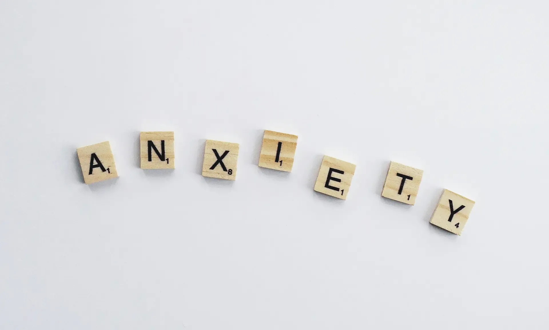 Scrabble tiles spelling the word ANXIETY