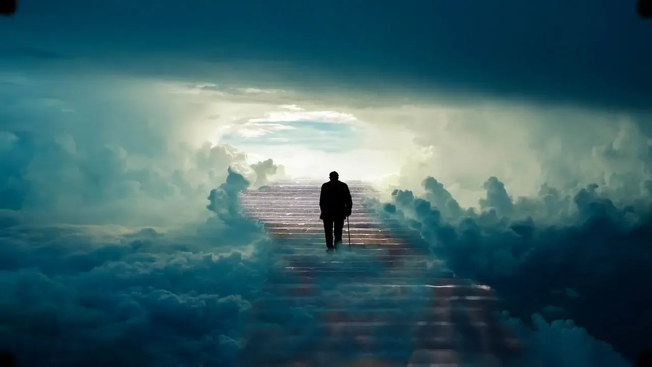 Figure walking along a path through clouds at sunrise