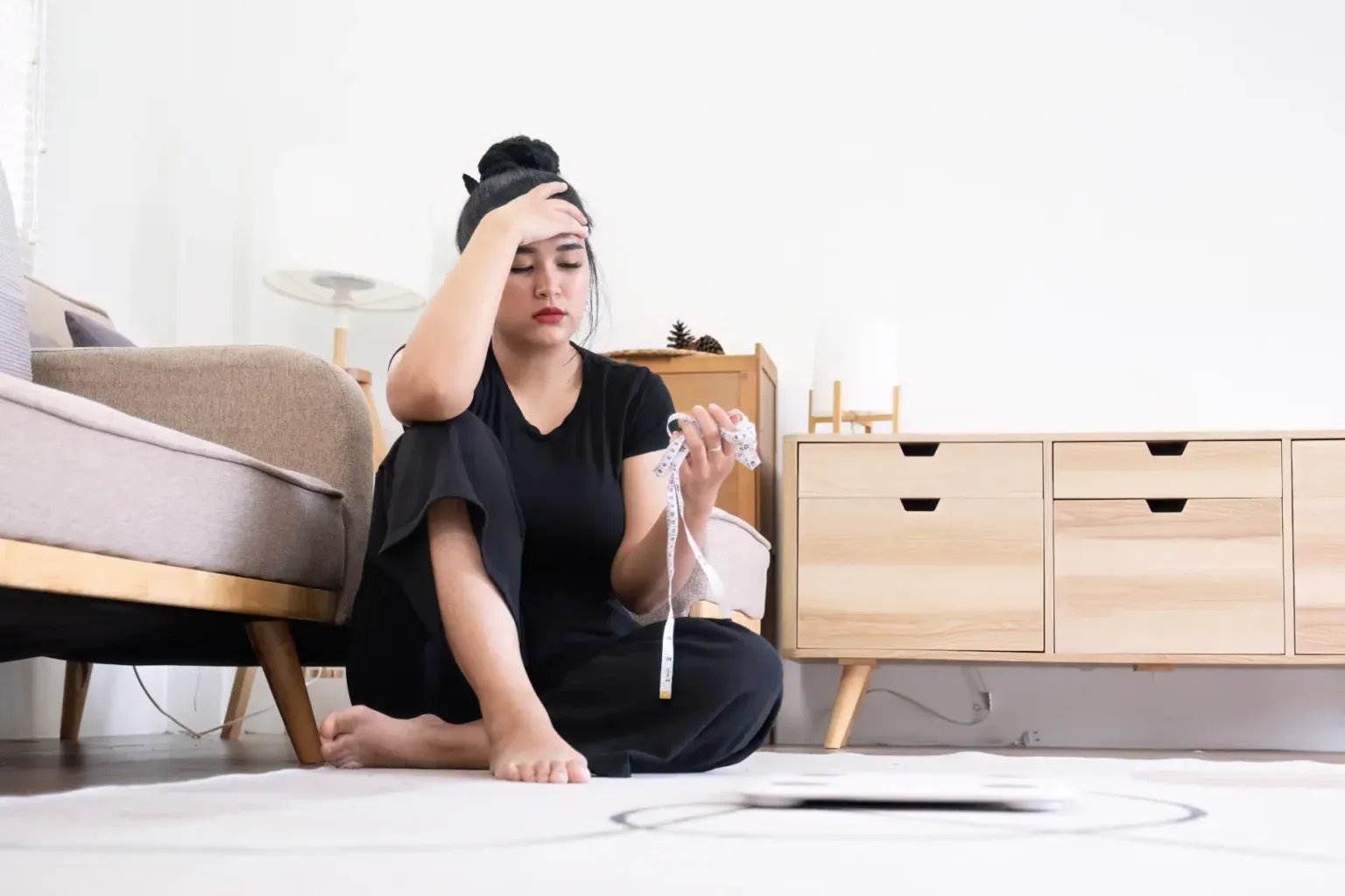 Woman sitting and reflecting on her weight loss journey