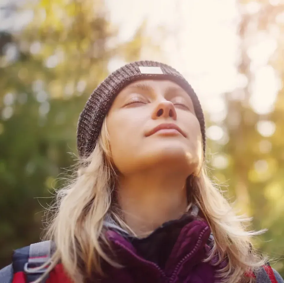 Woman breathing in fresh air outdoors