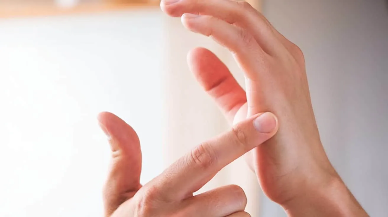 Two hands resting together in a comforting gesture