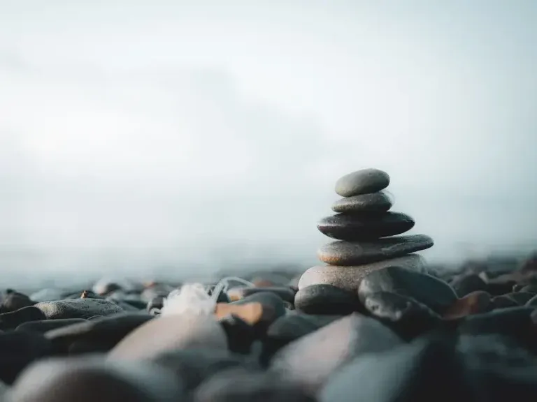 A stack of smooth balanced stones beside the sea