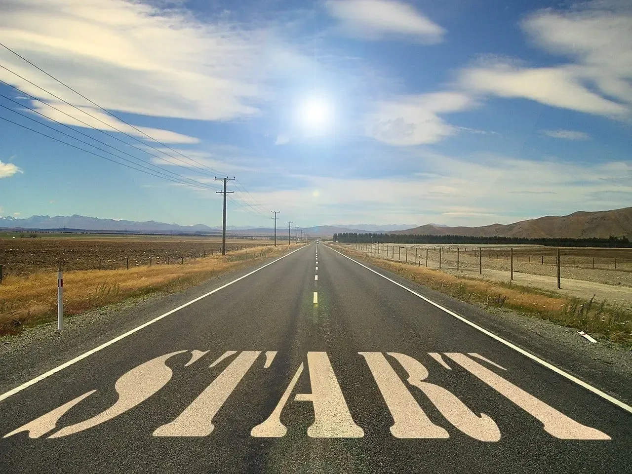 Open road with the word START painted on the asphalt